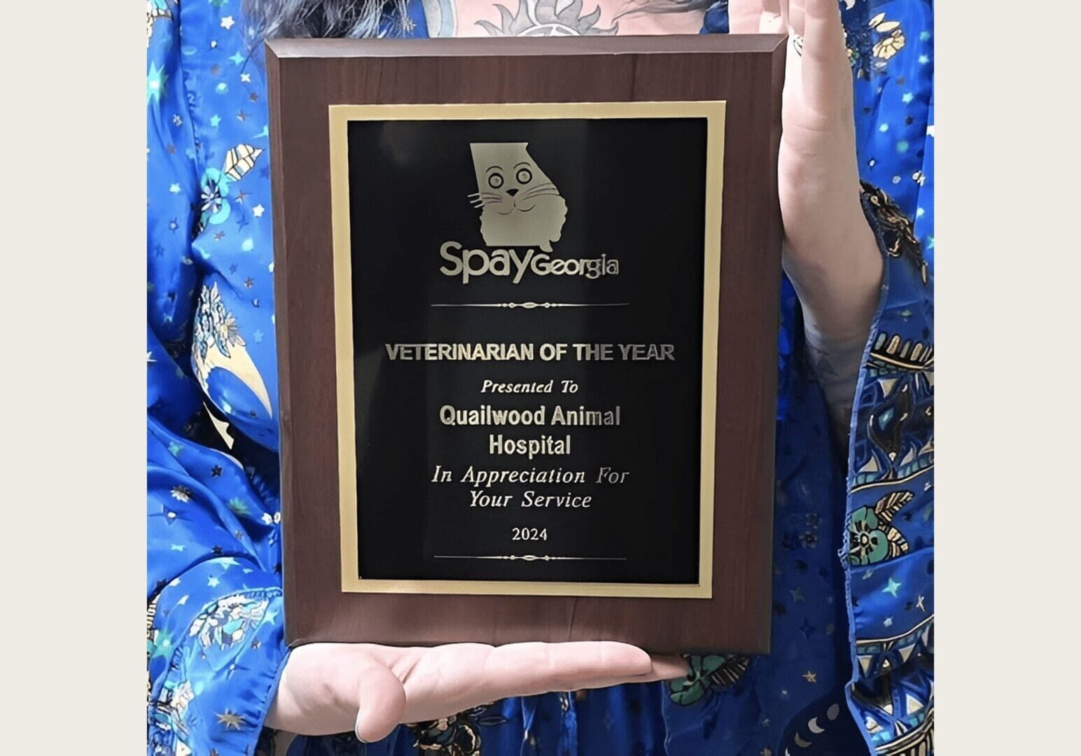 Spay Georgia award held by person